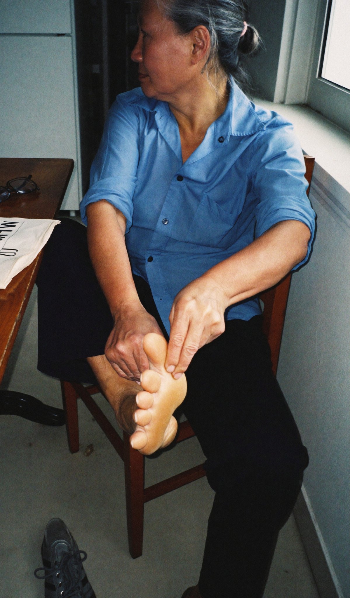 Rubbing a sore foot at 4 pm